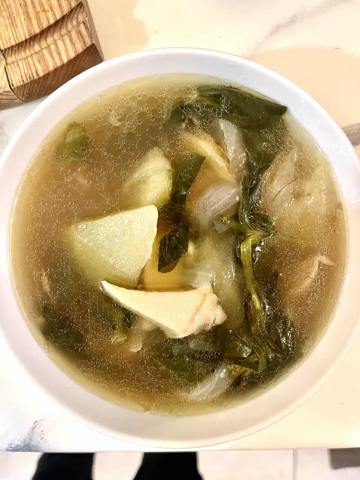 Chrysanthemum and green vegetable herbal soup, healthy natural remedy for wellness.