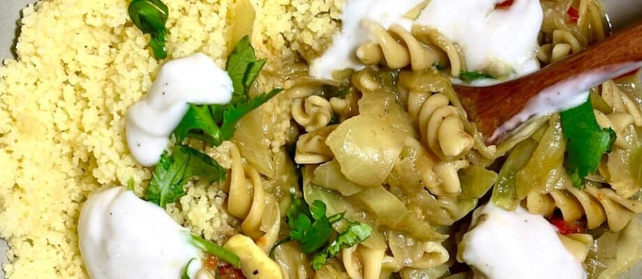 Gluten-free pasta with cauliflower couscous and creamy sauce, healthy plant-based meal.