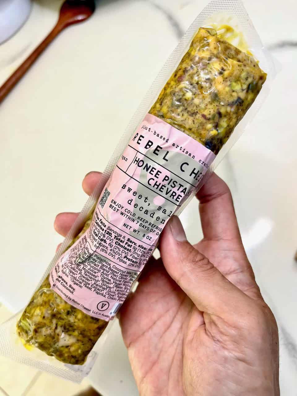 Savory herbal cheese with honey, pistachios, and chevre in recyclable packaging.