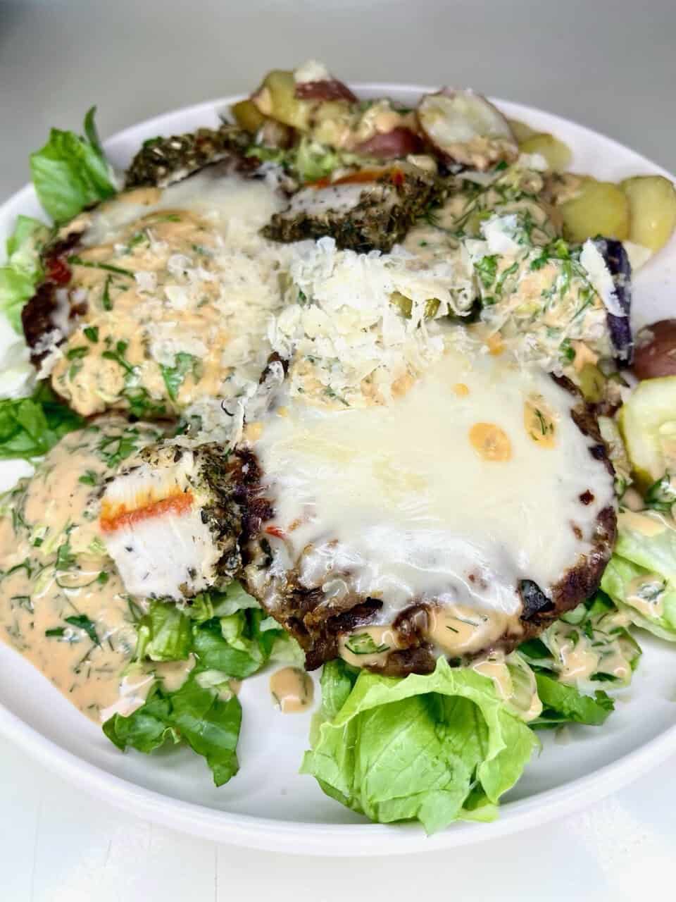 Fresh homemade salad with melted cheese, grilled chicken, vegetables, and creamy dressing, healthy and flavorful.