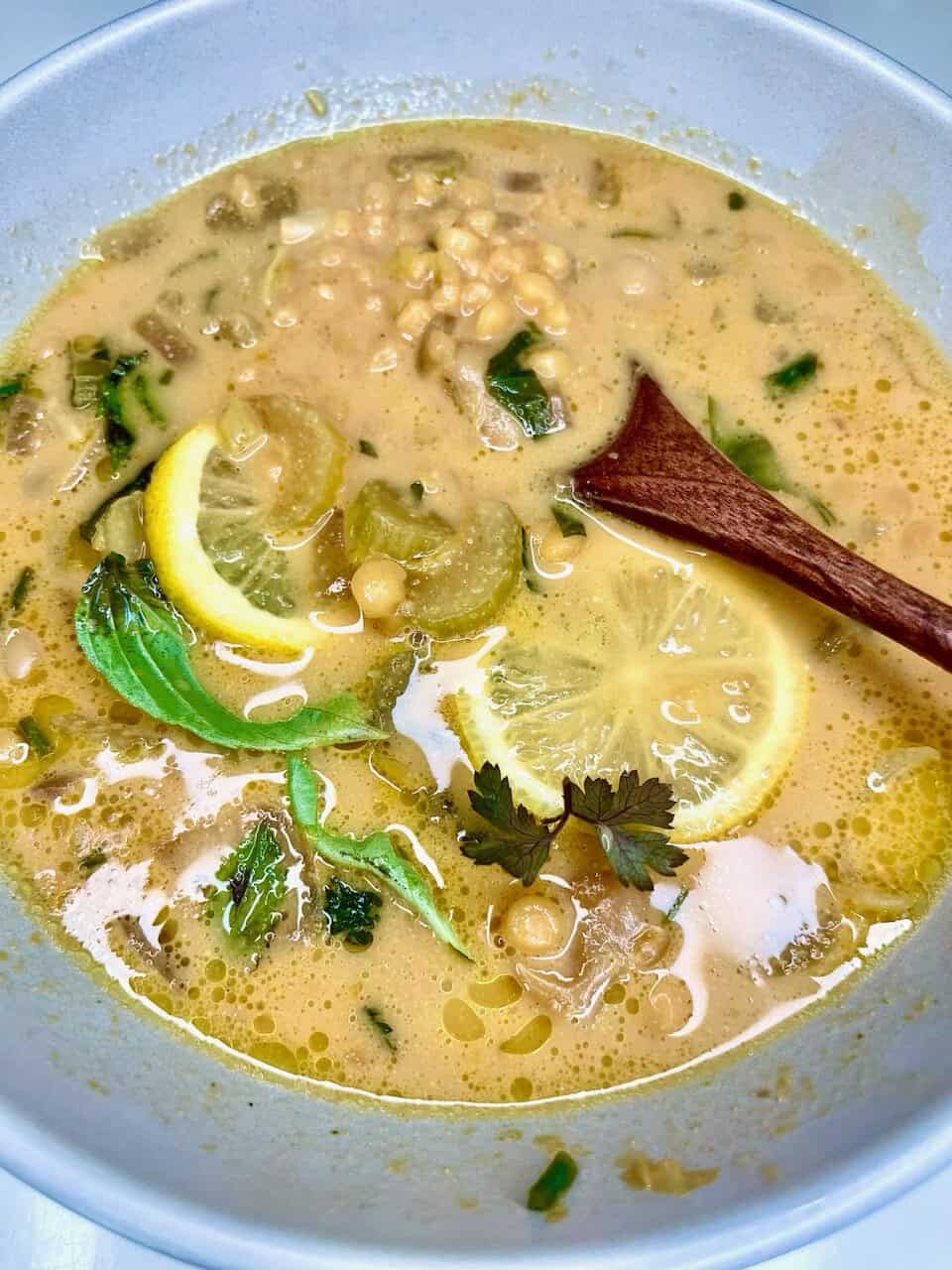 Creamy lemon lentil soup with fresh herbs and vegetables, perfect for healthy, nourishing vegetarian meals.