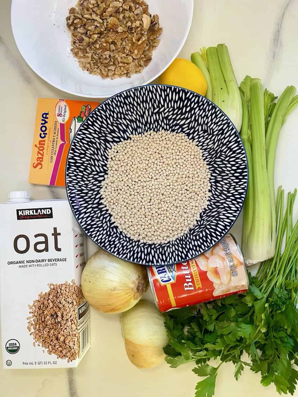 Healthy vegan ingredients for making purethyheart soup, including oats, celery, lemon, onions, and canned artichoke hearts.