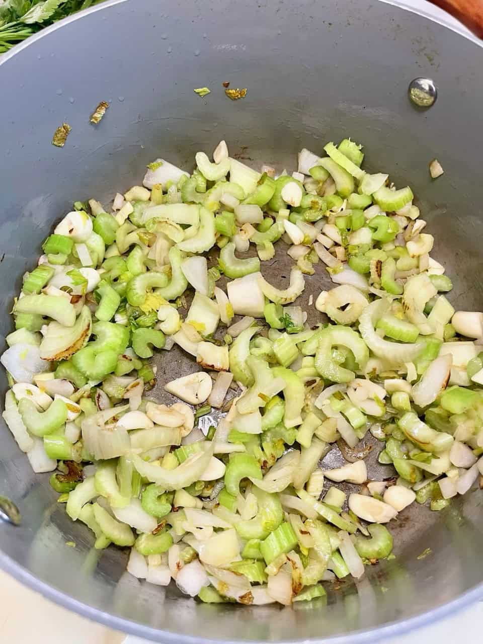 Chopped celery and garlic cooking in a gray skillet, healthy vegetarian ingredients, meal preparation, culinary cooking process, Make Pure Thy Heart.