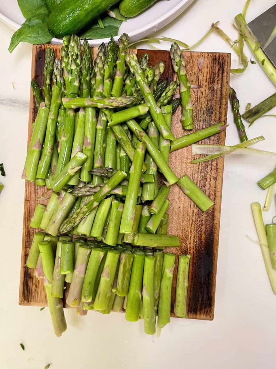 Fresh green asparagus spears on a wooden cutting board, healthy vegetable for nutritious meals.