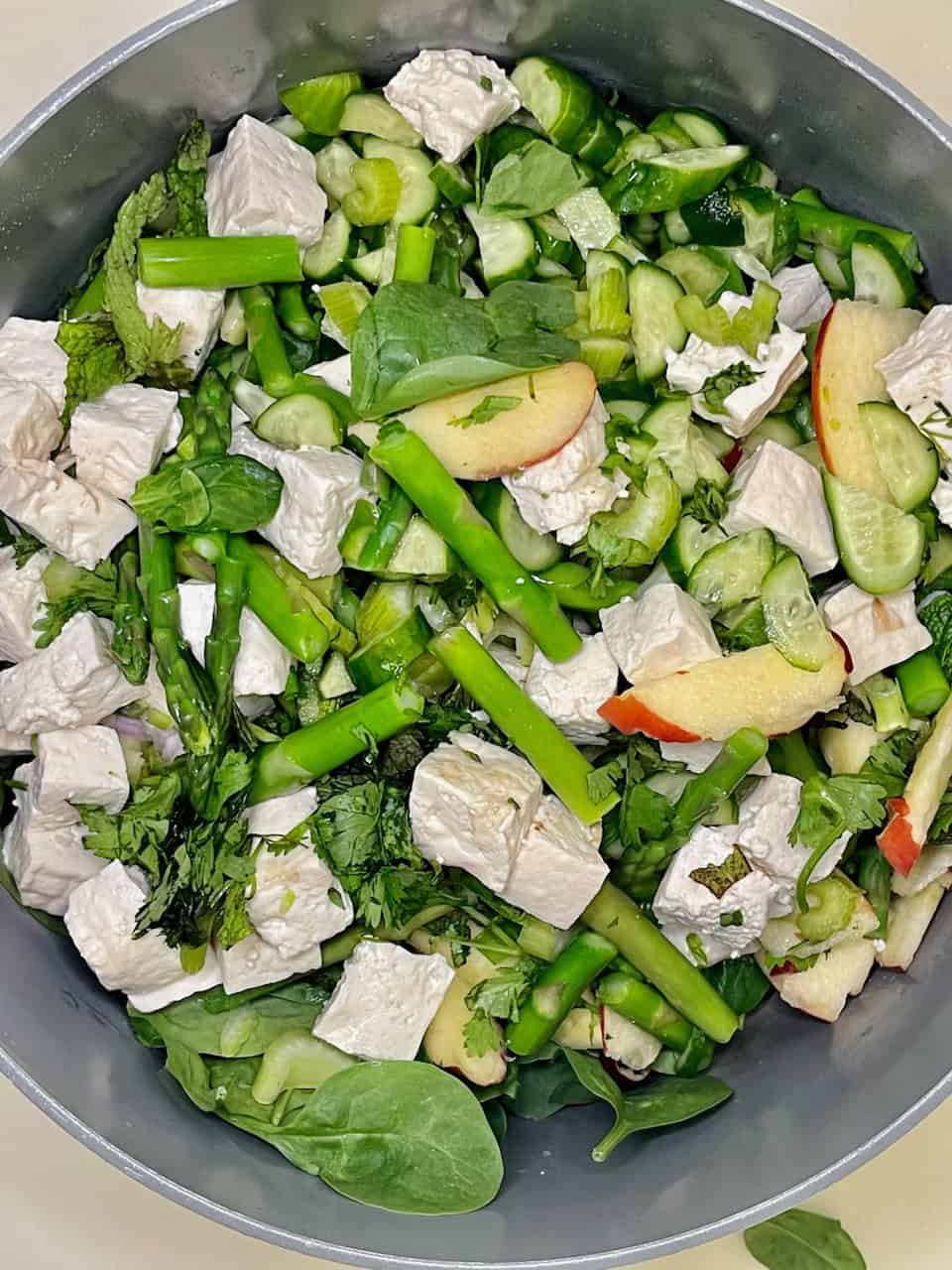 Fresh veggie salad with apples and feta cheese, promoting healthy eating and wholesome living.