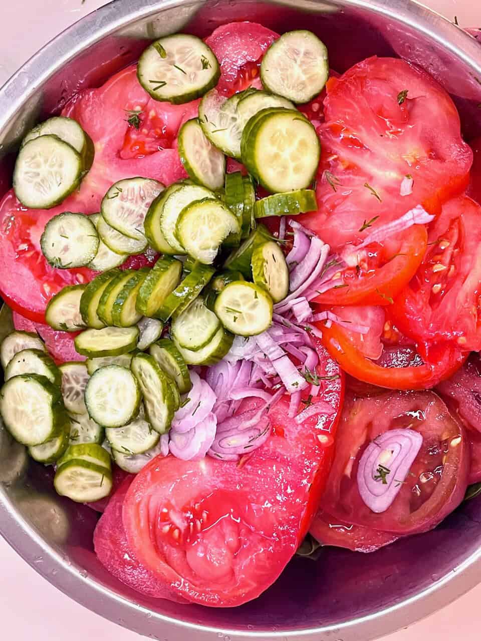 Cucumber, tomato, and onion salad with fresh herbs, healthy and refreshing vegetable medley.
