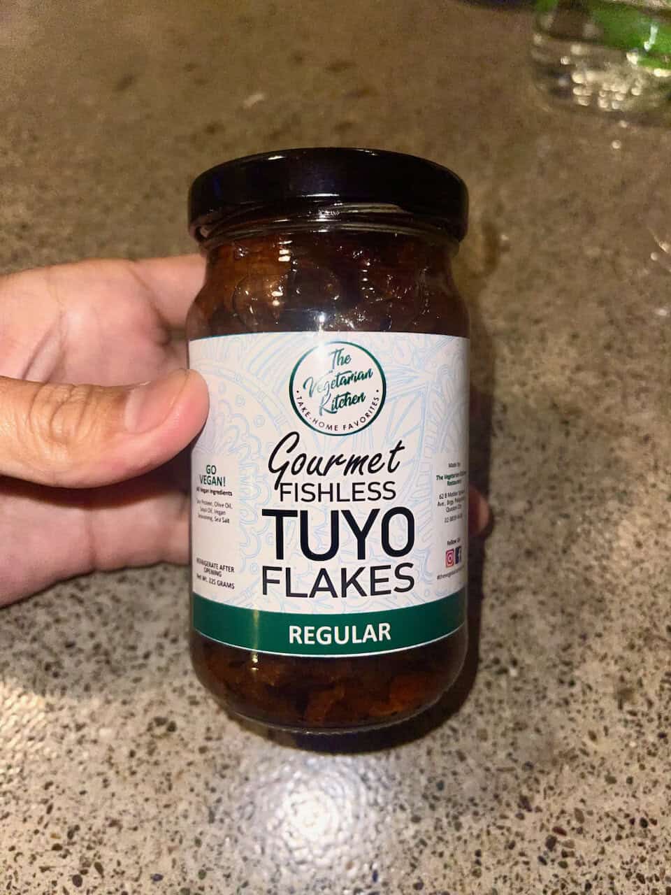 Vegan gourmet fishless Tuyo flakes jar on a countertop.