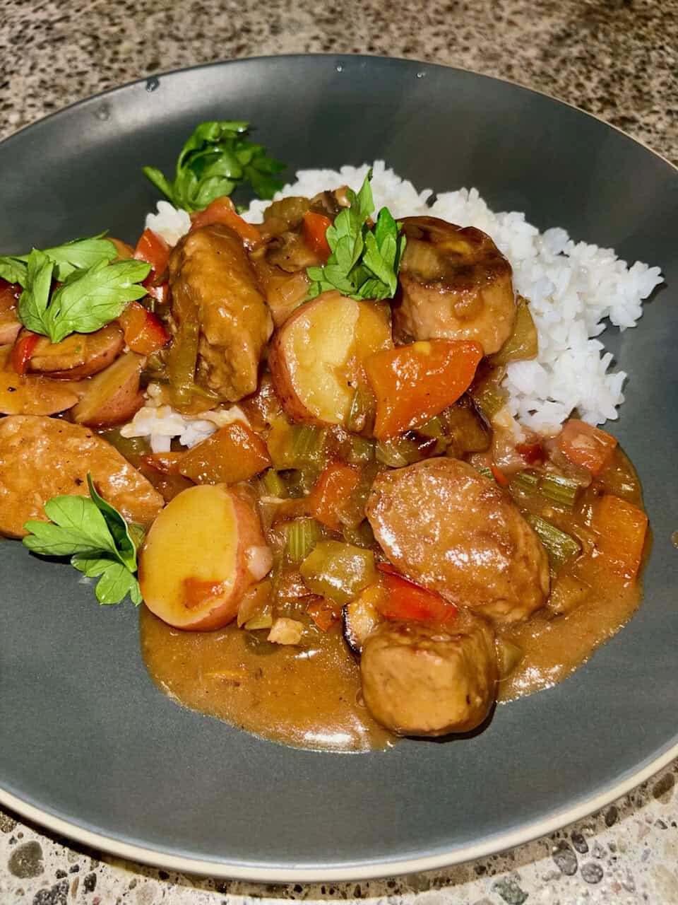 Hearty homemade chicken and vegetable stew served over white rice, garnished with fresh herbs, nutritious comfort food for healthy living.