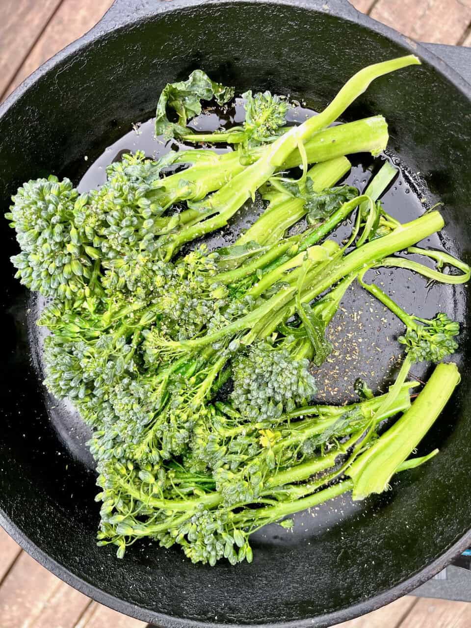Fresh broccolini cooking in a cast iron skillet, highlighting healthy vegetables and plant-based nutrition.