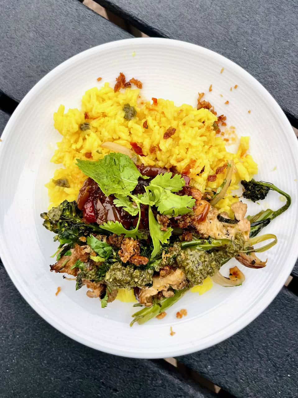 Butternut squash vegan rice bowl with greens and herbs, healthy plant-based meal.