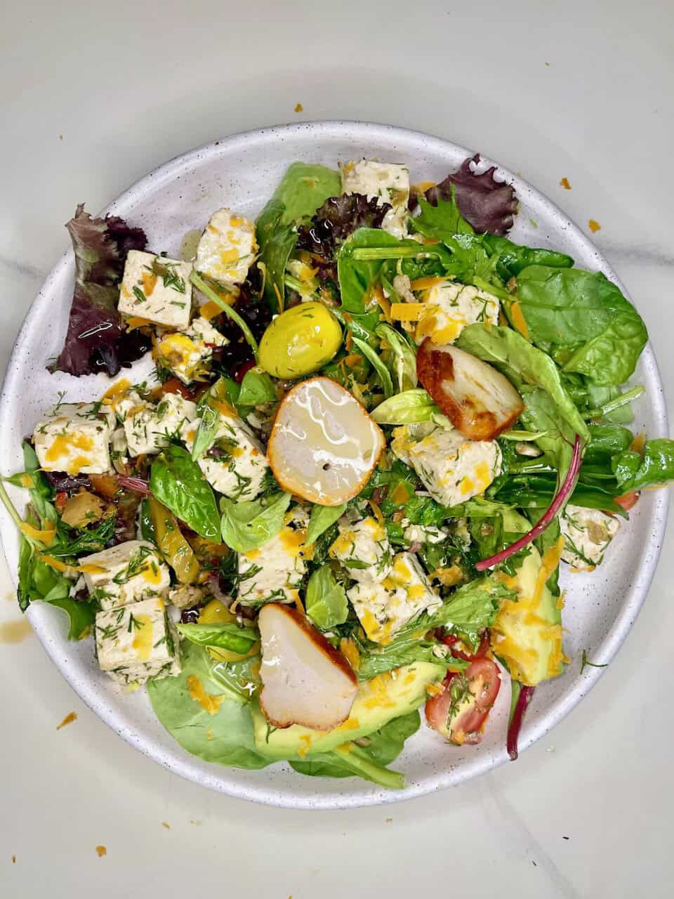 Fresh garden salad with feta cheese, cherry tomatoes, and mixed greens, emphasizing healthy eating and wellness.