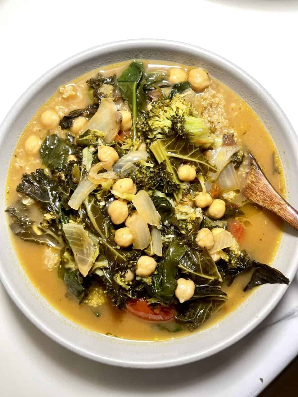Hearty vegetable and chickpea soup with kale and broccoli, healthy plant-based meal, vegan food, nutritious lunch or dinner option ready to serve.