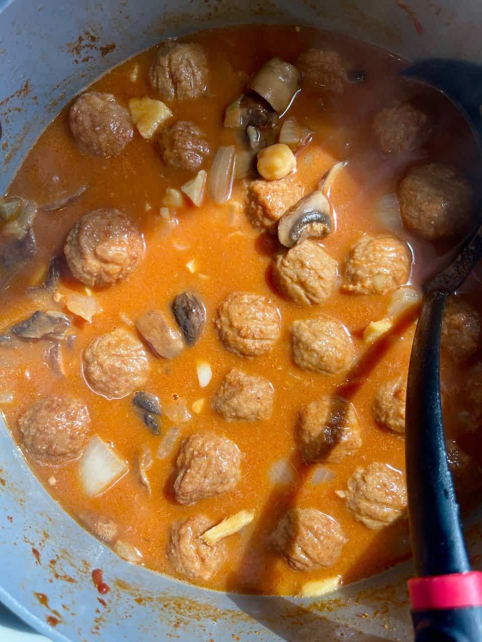 Savory meatball soup cooked in flavorful broth with mushrooms and onions for homemade comfort.