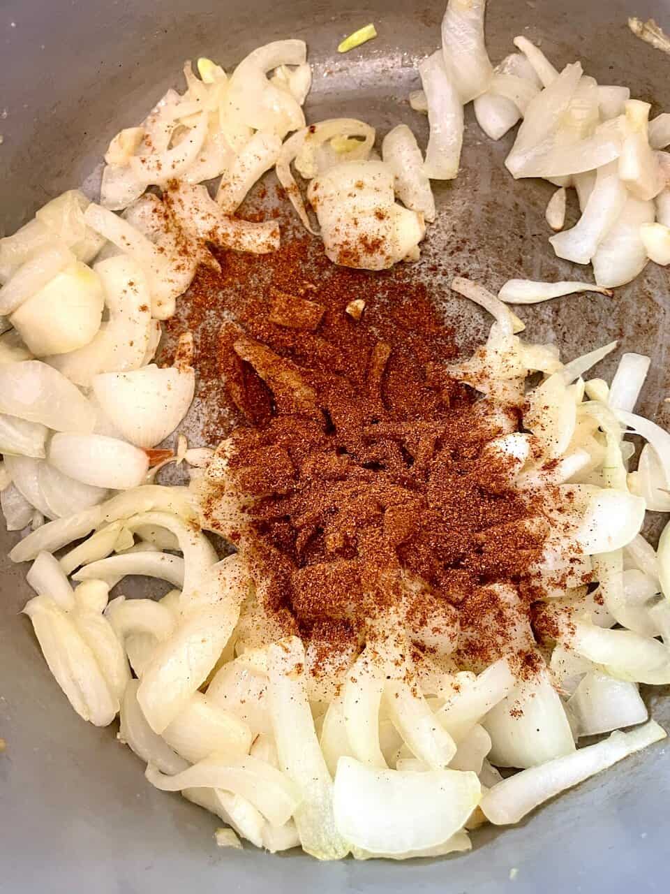 Sautéing onions with spices for healthy, nourishing cooking.