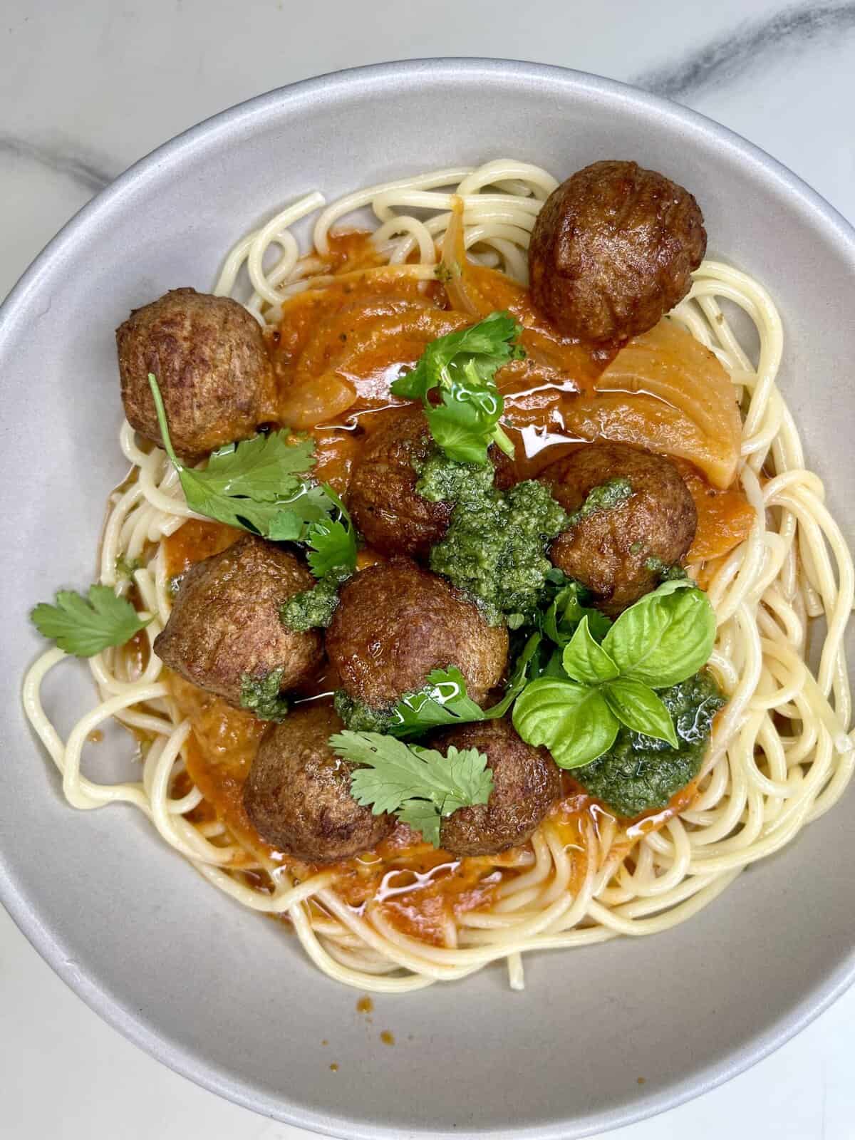 Savory spaghetti with meatballs and fresh herbs, perfect for a healthy, heartwarming meal.