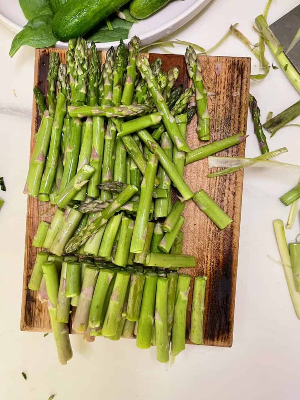 Fresh green asparagus spears on a wooden cutting board for healthy eating and nutritious meals.