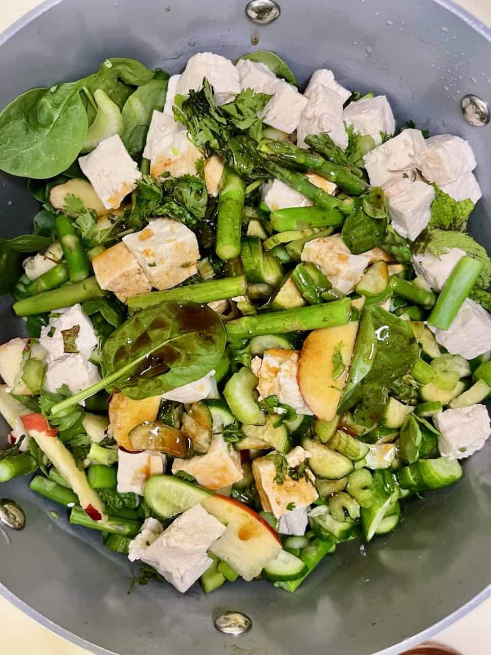 Fresh vegetable salad with tofu, greens, and herbs for healthy eating.