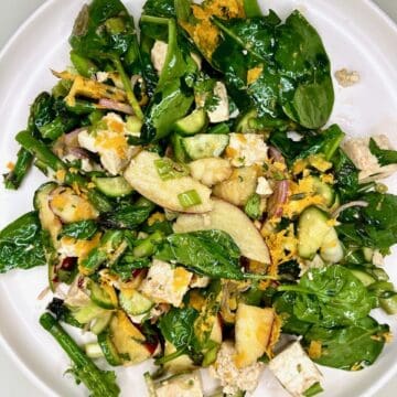 Fresh green vegetable salad with tofu and egg, healthy plant-based meal for wellness.