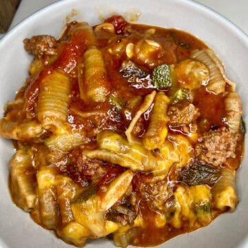Savory pasta dish with ground meat, vegetables, and rich tomato sauce.