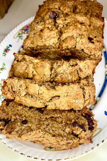 Delicious homemade oatmeal raisin banana bread on a floral plate.