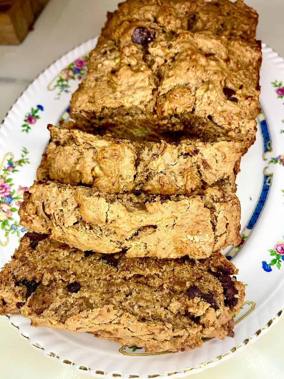 Delicious homemade oatmeal raisin banana bread on a floral plate.