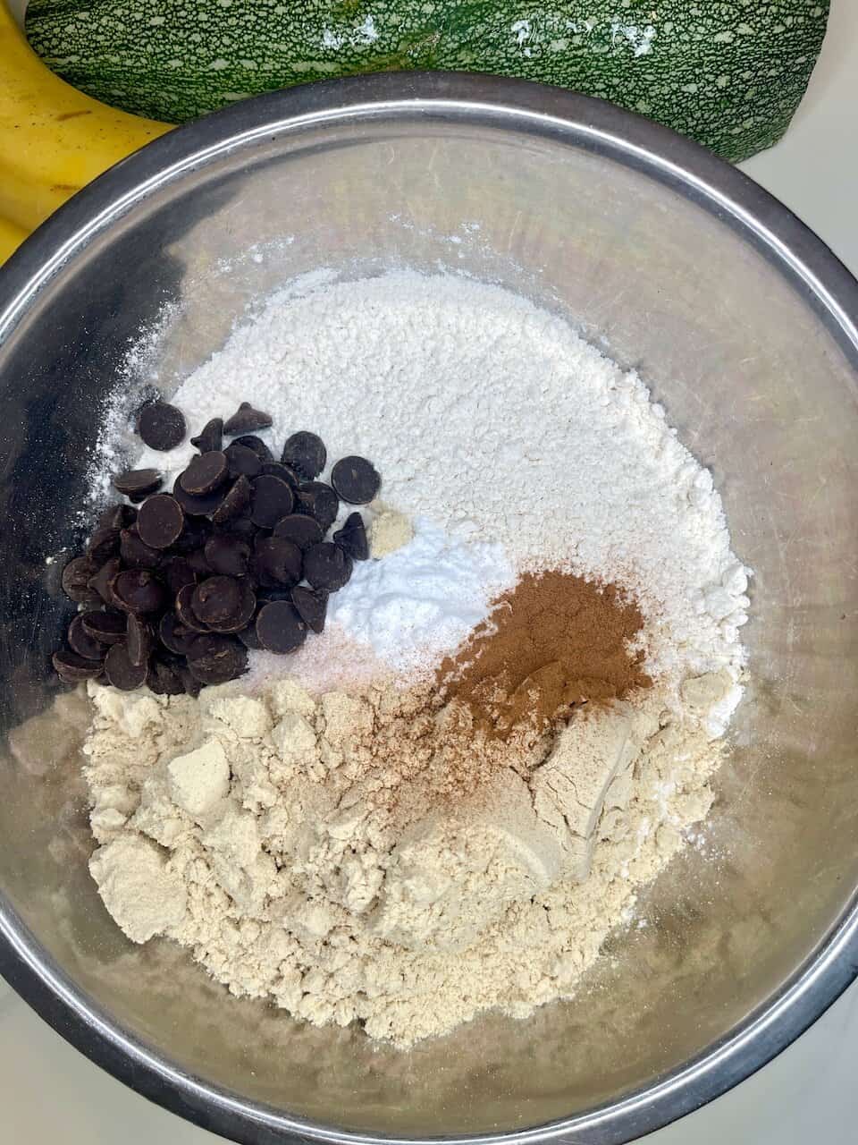 Chocolate chip and cocoa powder ingredients in a mixing bowl for baking.