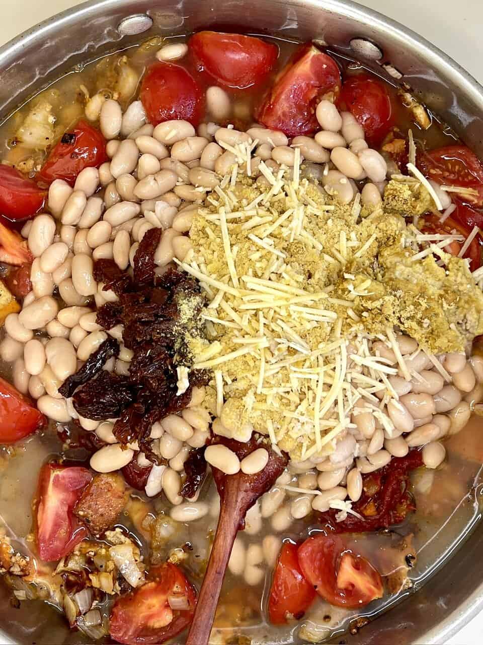 Beans, tomatoes, cheese, cooking, healthy meal, wholesome ingredients, nutritious, plant-based, homemade cooking, culinary process, food preparation.