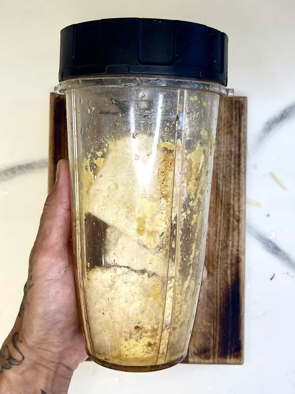 Blender with leftover ingredients for healthy smoothie or cooking, used for making nutritious blends for wellness and vitality.