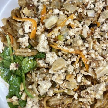Crumbled tofu and vegetable stir-fry with pasta, healthy plant-based meal, gluten-free and vegan Friendly.
