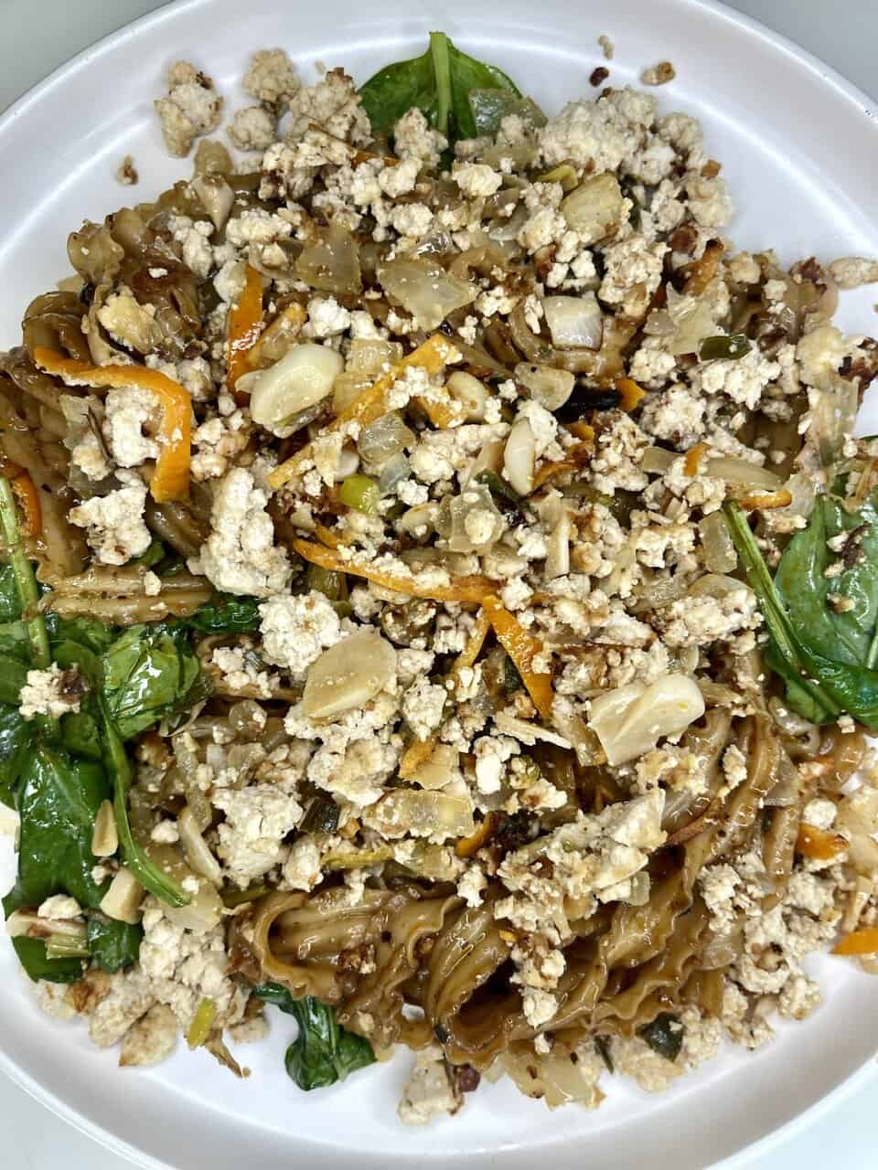 Ground turkey vegetable stir-fry with noodles, healthy meal, made with fresh ingredients on a white plate.