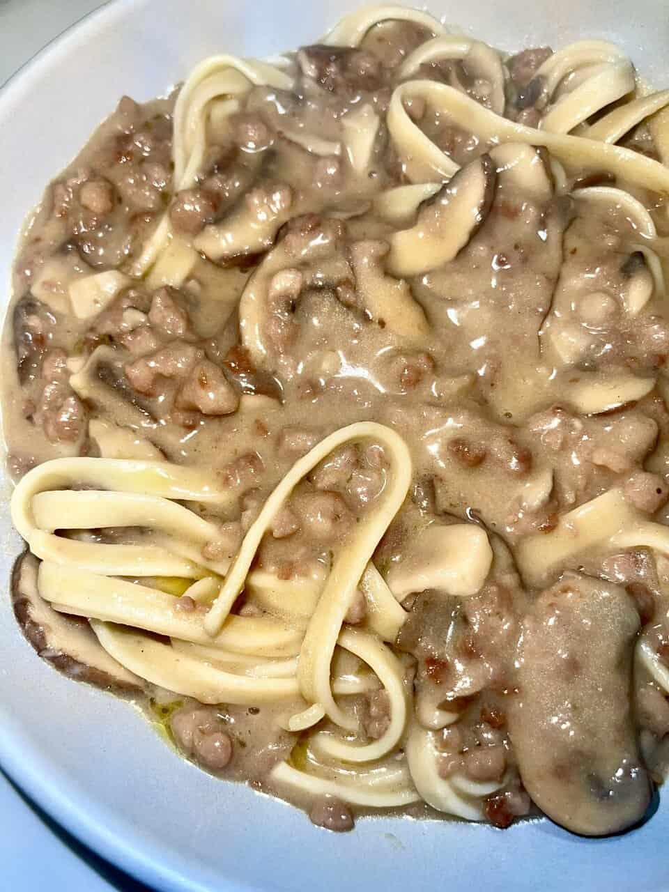 Savory mushroom lentil pasta in creamy sauce, healthy plant-based meal for detox and wellness.