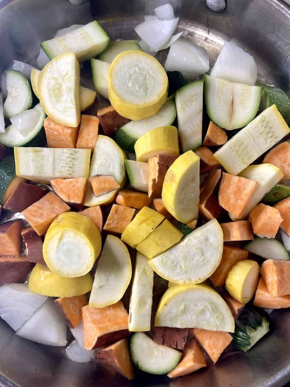 Bowl of vegan kids’ pasta with hidden vegetable sauce topped with fresh basil