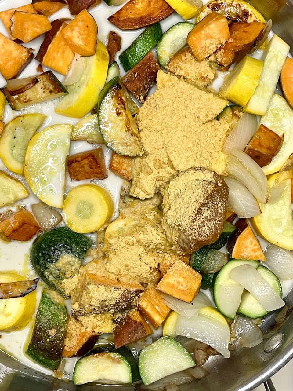 Bowl of vegan kids’ pasta with hidden vegetable sauce topped with fresh basil