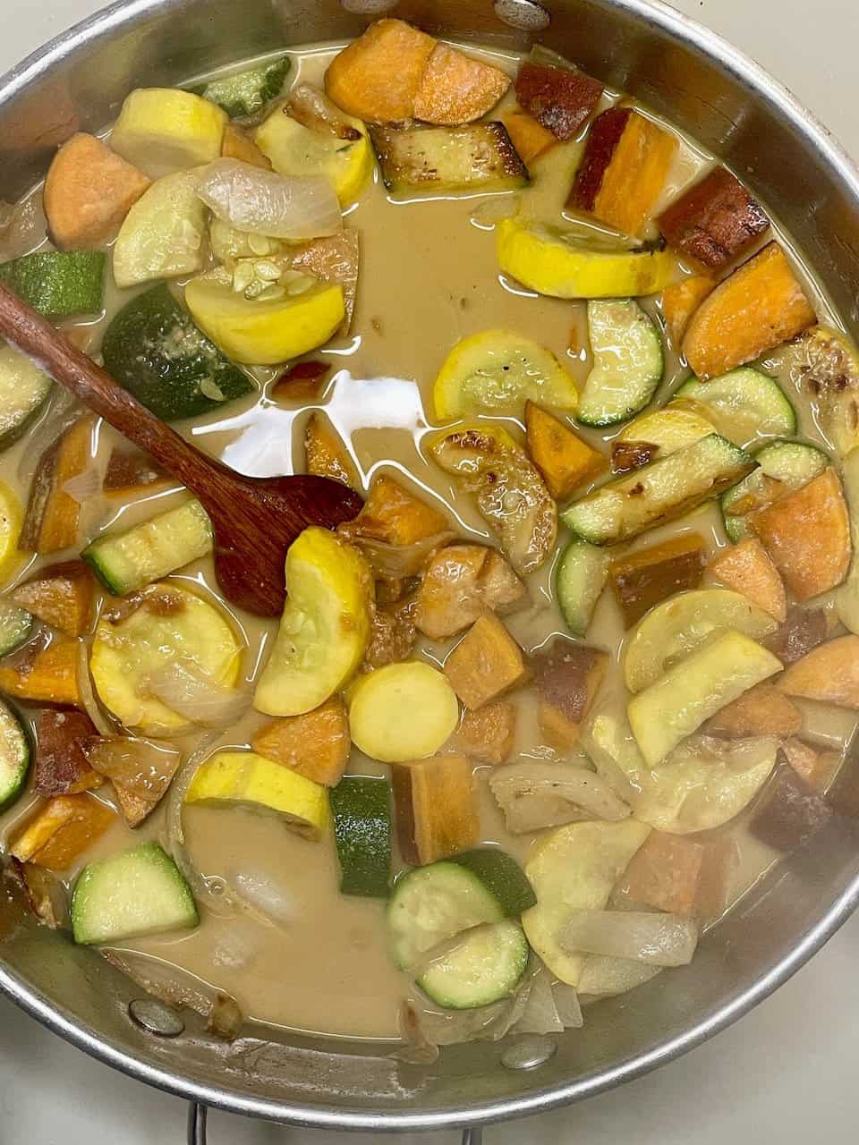 Bowl of vegan kids’ pasta with hidden vegetable sauce topped with fresh basil