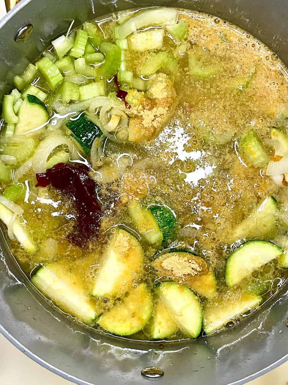 Fluffy, light zucchini soup cooking process, healthy vegetable broth, fresh ingredients for nourishing meal.