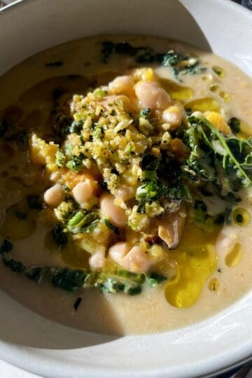 Creamy vegan soup with roasted squash, white beans, greens, and coconut-miso broth.