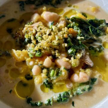 Creamy vegan butternut squash stew with beans and greens.