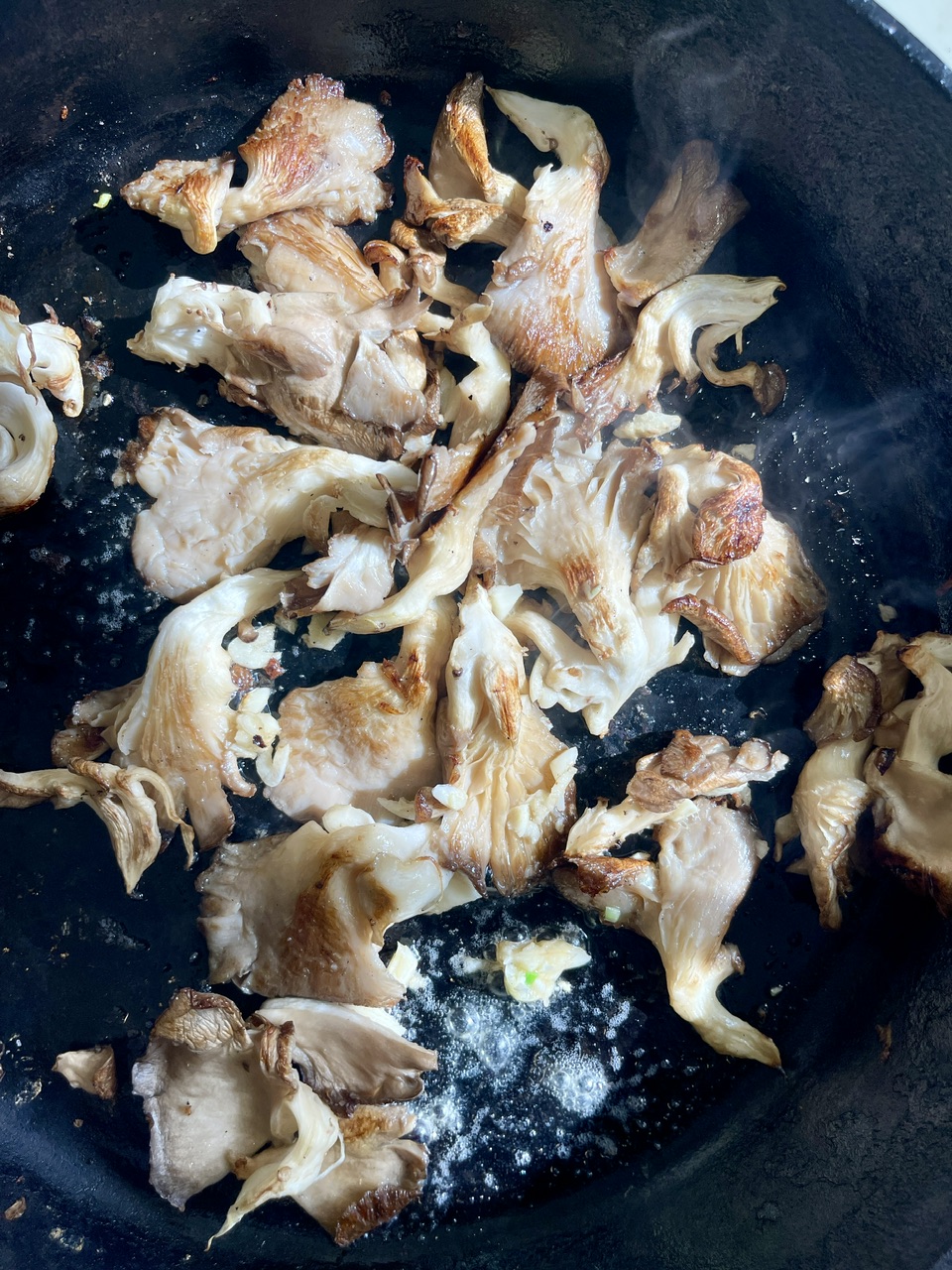 Sautéed mushrooms in a pan, ready for vegan risotto.