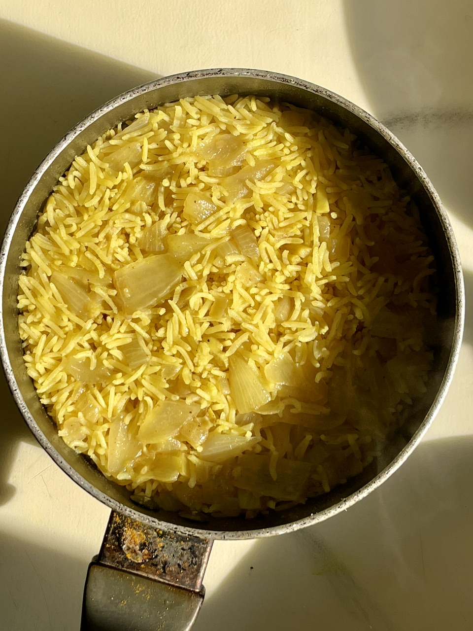 Vegan biryani rice with tofu and vegetables in a pot.