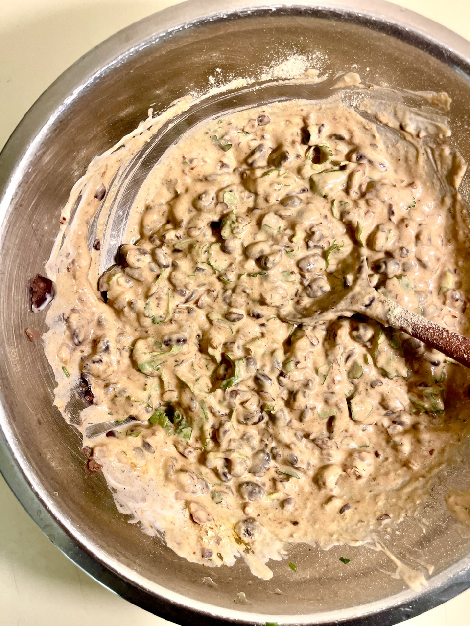 Creamy vegan yogurt bean mixture with chopped vegetables in a bowl.