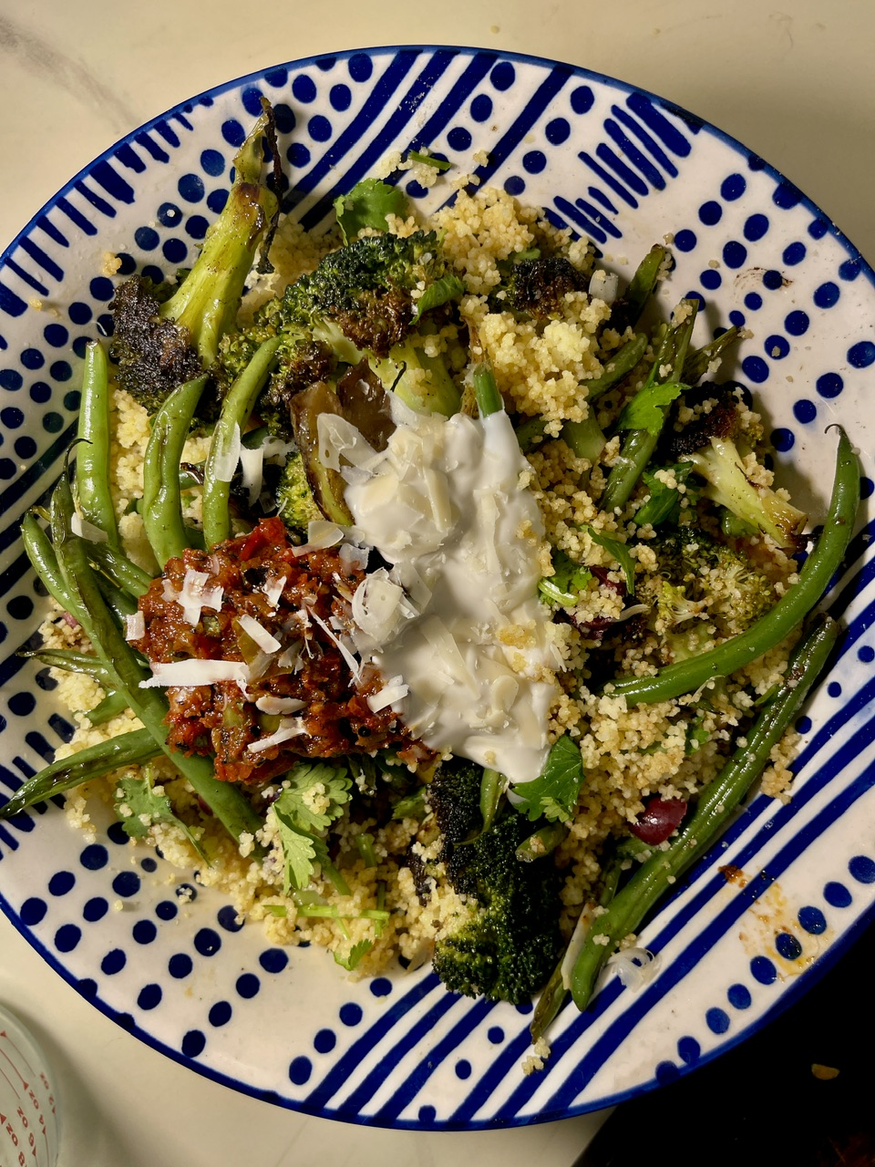 Healthy Mediterranean couscous salad with green beans, broccoli, and feta cheese.