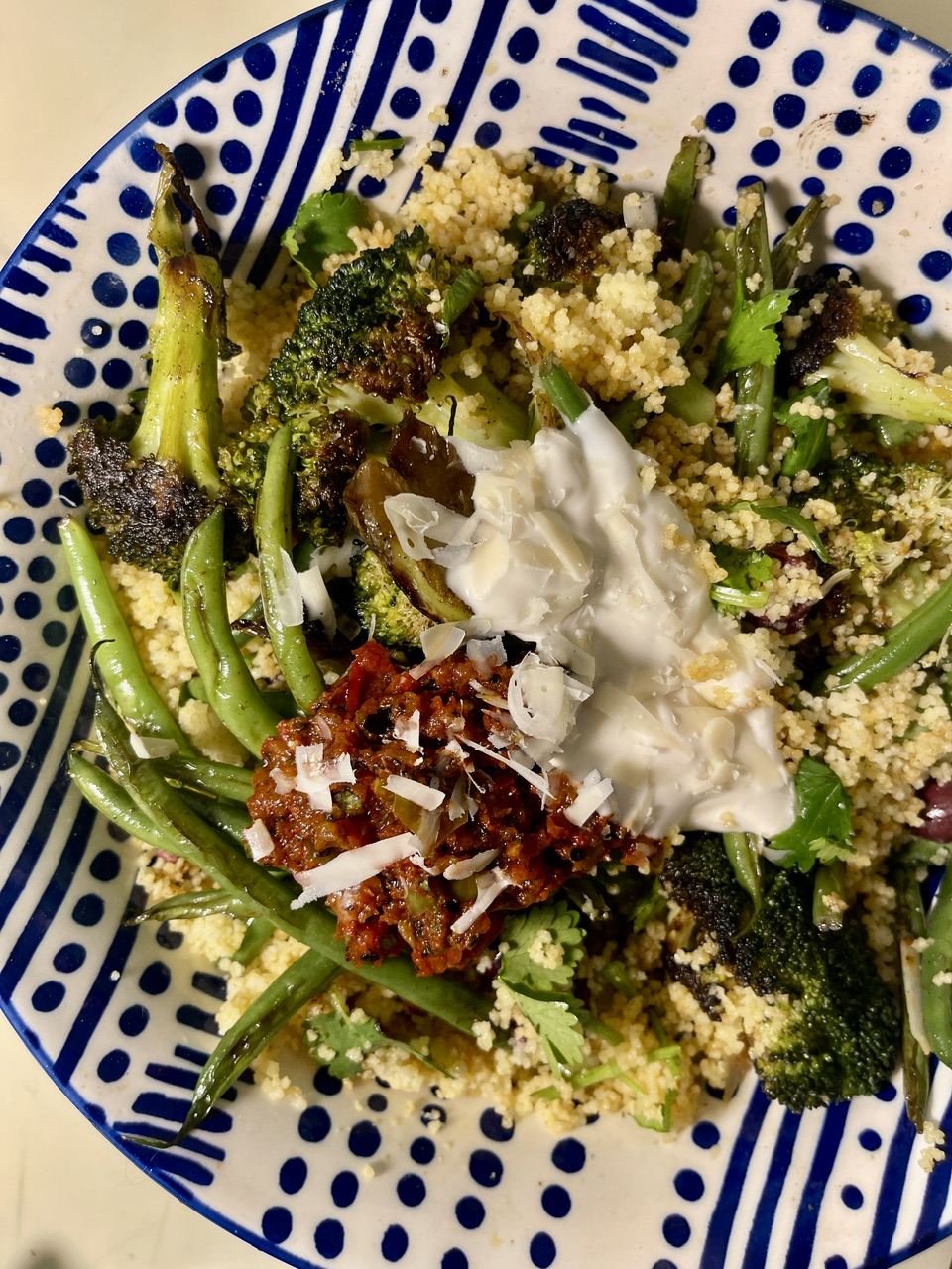Healthy Mediterranean couscous with green beans, broccoli, and feta cheese.