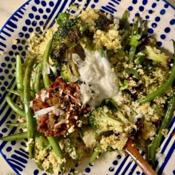 Healthy Mediterranean couscous with green beans, broccoli, and feta cheese.